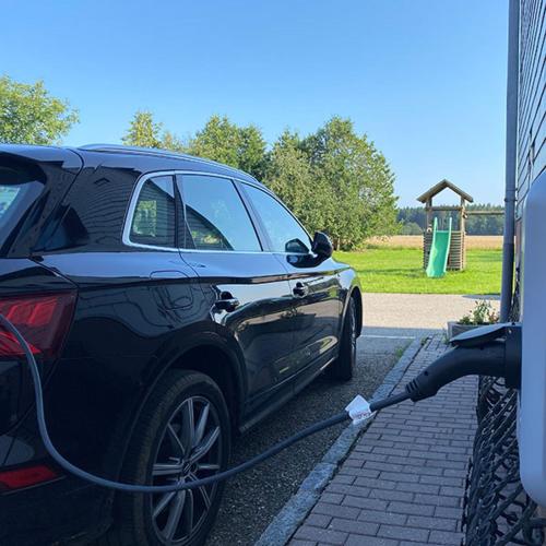 a car is being hooked up to a house at Hotel z'Leithen in Weng im Innkreis