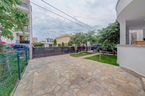 a walkway outside of a house with a fence at Holiday Home Adria in Dobra Voda