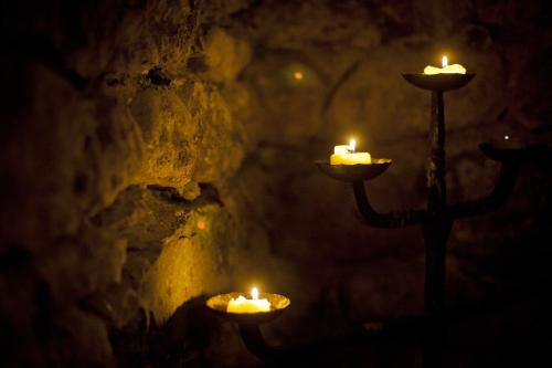 a candle holder with candles in a dark room at Auberge du Raisin in Cully