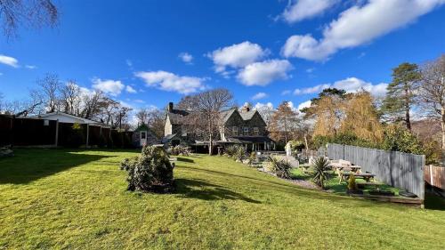 a yard with a house in the background at Hafan Artro in Llanbedr