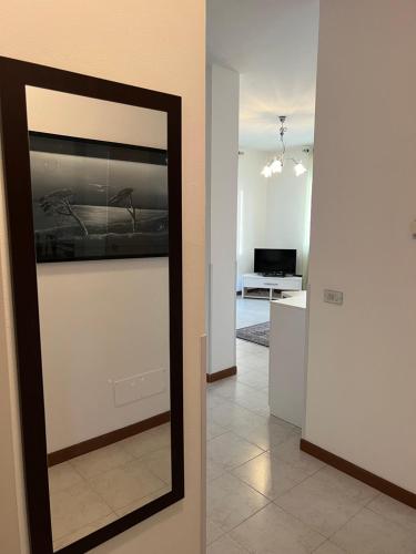 a mirror leaning against a wall in a room at A DREAM ON THE LAKE Via Roma in Lierna
