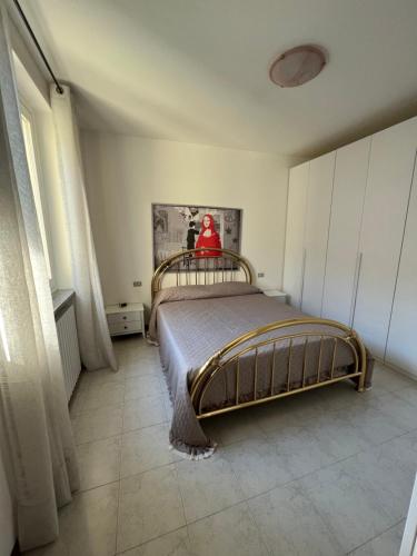 a bedroom with a bed with a red object on it at A DREAM ON THE LAKE Via Roma in Lierna
