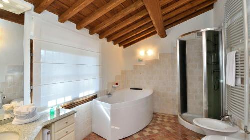 a bathroom with a tub and a toilet and a sink at Podere La Casa in Cavriglia