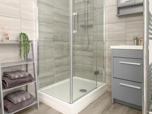 a shower with a glass door in a bathroom at Porters Vault in Thirsk