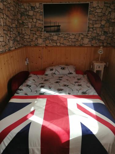 ein Bett in einem Zimmer mit einer Flagge darauf in der Unterkunft Schäferwagen Rotkelchen in Ratingen
