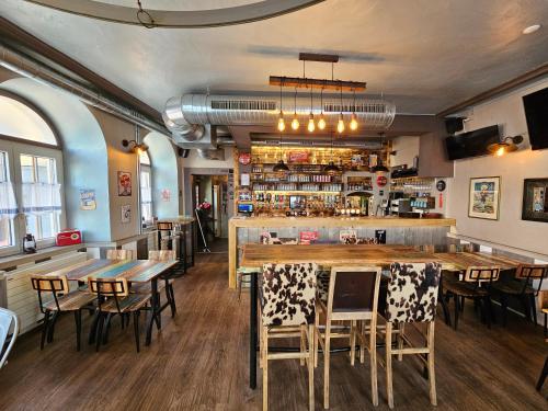 a restaurant with tables and chairs and a bar at La Croix Fédérale in Porrentruy
