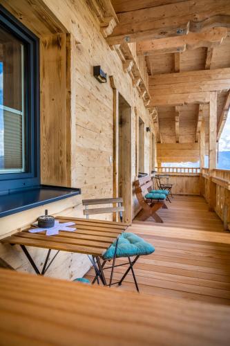 a room with wooden walls and a wooden table and chairs at Taurachhof Astlehen in Alpendorf