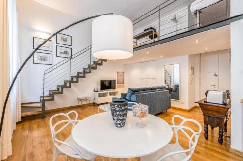 a living room with a white table and chairs at Loft Crocetta in Turin