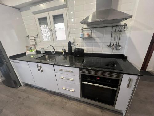 a kitchen with a stove and a sink at Sweet Home in Valencia