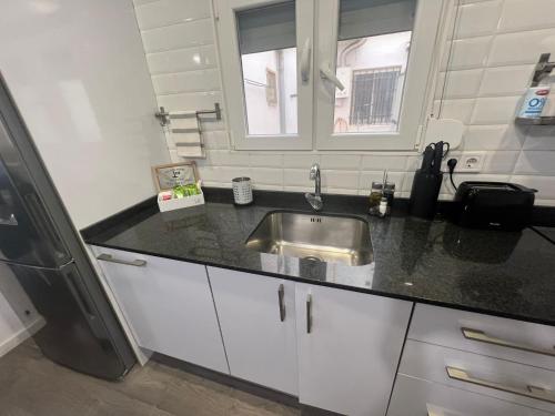 a kitchen with a sink and a refrigerator at Sweet Home in Valencia