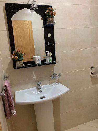 a bathroom with a sink and a mirror at Beralmar Asilah Chez FATIMA in Asilah