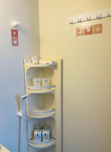a refrigerator with four shelves in a room at Warm House2 in Sapporo