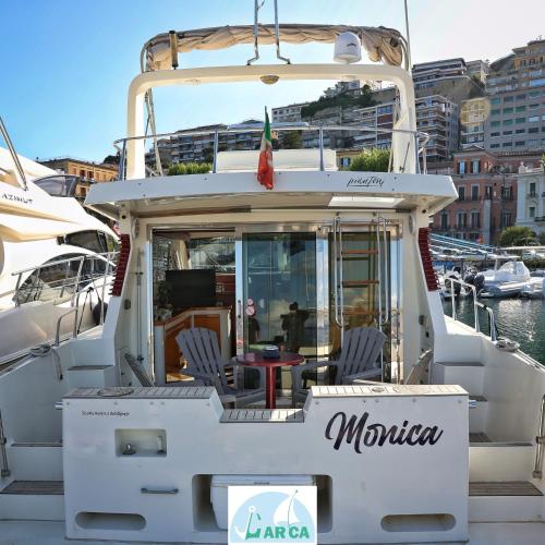 a man sitting on a boat in a marina at Boat Breakfast Monica in Naples