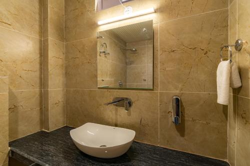 a bathroom with a toilet and a sink at The Social Stays Manali formerly ArtBuzz in Manāli