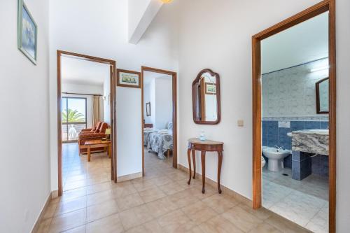 a room with a bathroom with a sink and a toilet at Beach Front A in Luz