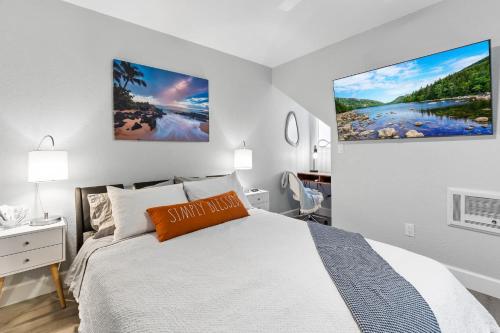 a bedroom with a bed and a large painting on the wall at Endless Sunset- Near Beach Surf and Pet Friendly in Huntington Beach