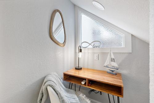 a bathroom with a wooden table and a mirror at Endless Sunset- Near Beach Surf and Pet Friendly in Huntington Beach