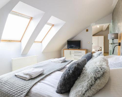 sypialnia z łóżkiem i poduszkami w obiekcie Avangard by Baltic Home w Świnoujściu