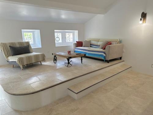 a living room with a couch and a coffee table at Chez Romain et Saphie in Les Baux-de-Provence