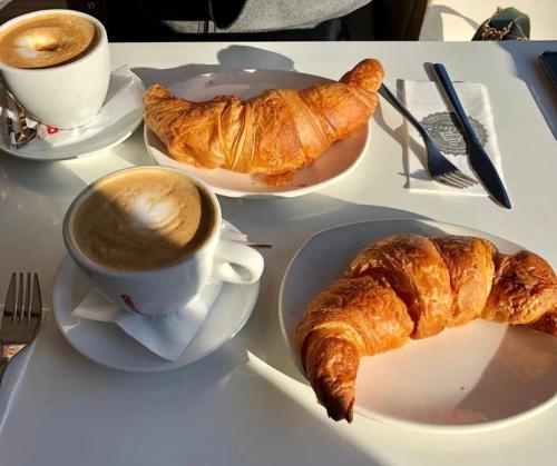 a table with a cup of coffee and croissants on it at B&B LA VILLA Rozzano - HUMANITAS - FORUM ASSAGO - MILANO FIORI - IEO in Rozzano