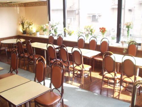a row of tables and chairs in a room at Himeji Green Hotel Sakamoto in Himeji