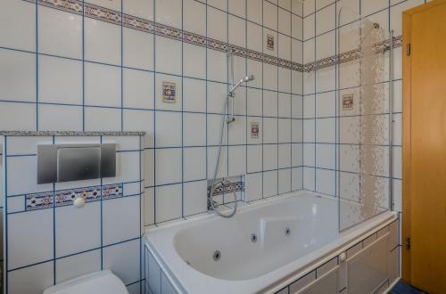 a bathroom with a tub and a toilet at Holiday home Nika in Linardići