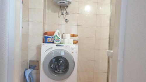 a washing machine in a bathroom next to a wall at Apartman Amela in Mostar