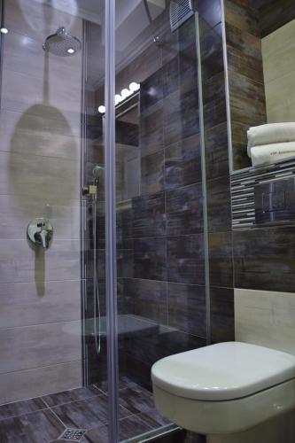 a bathroom with a toilet and a glass shower at VIP Apartments Sofia in Sofia