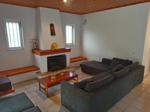 a living room with a couch and a fireplace at Alykesbeachhouse in Drosia