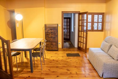 a living room with a table and a couch at GITE URBAIN - Côté bourg in Rodez