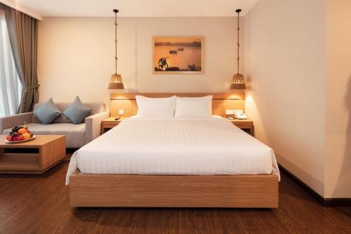 a hotel room with a bed and a couch at Virgo Hotel Nha Trang in Nha Trang