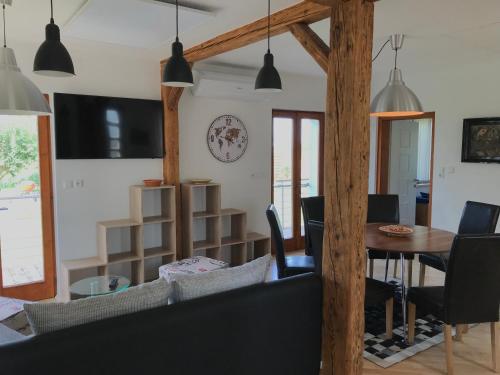 a living room with a table and chairs at Haus Fjord in Am See