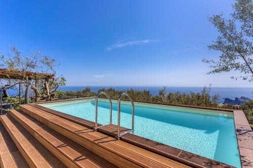 a swimming pool with a view of the ocean at Villa Rusinella Minimalist Retreat with Sea Views by Feeling Italy in Massa Lubrense