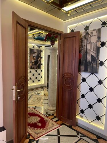 a hallway with an open door with a mirror at Le palace suite by pestana hôtel in Casablanca