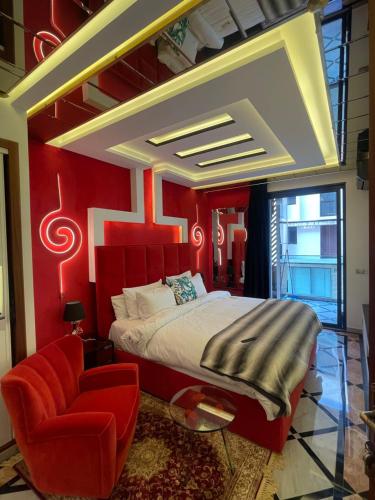 a bedroom with a large bed and a red wall at Le palace suite by pestana hôtel in Casablanca