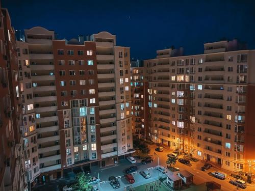 a view of a city at night with buildings at RentHouse Apartments Elegant in Chişinău