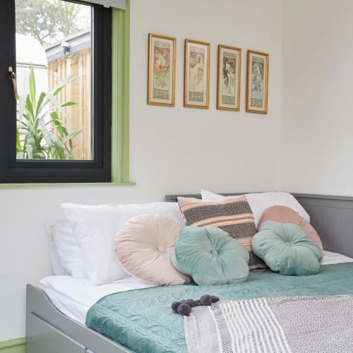 a bed with pillows on it in a room at Puckaster Cove Cabin in Niton