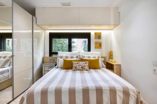 a bedroom with a large bed with yellow pillows at II-I Hub Luxury New Apartments in Barcelona