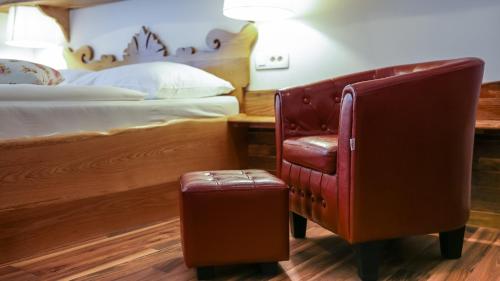 a hotel room with a bed and a chair at Central Bled House in Bled