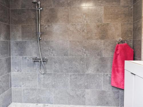a bathroom with a shower with a red towel at Swallowtail Lodge in Brundall