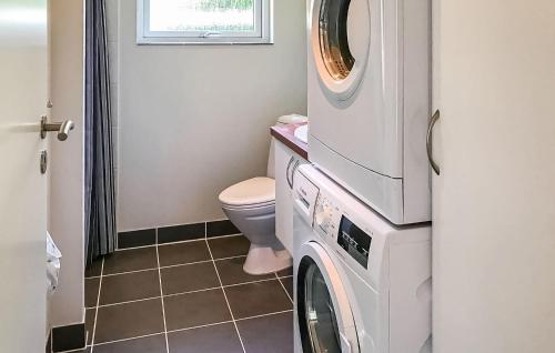 a washing machine in a bathroom with a toilet at Beautiful Home In Rønne With Wifi in Rønne