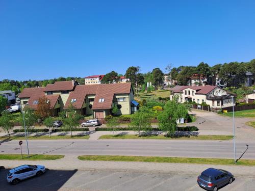 a residential neighborhood with cars parked in a parking lot at DREAMSVILLE in Ventspils