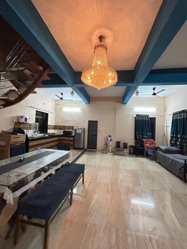 a large living room with a couch and a chandelier at VALLEY VIEW VILLA in Neral