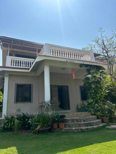 a house with a staircase in front of it at VALLEY VIEW VILLA in Neral