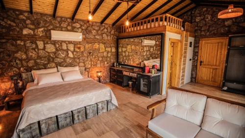 a bedroom with a bed and a desk in a room at Çandır Resort Restaurant in Muğla