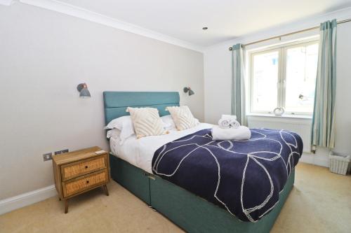 a bedroom with a bed with a teddy bear on it at APARTMENT BY THE BEACH The Foxcove in St Merryn