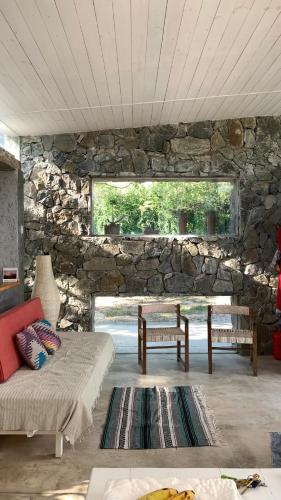 a living room with a stone wall and a couch at Jauja in San Javier