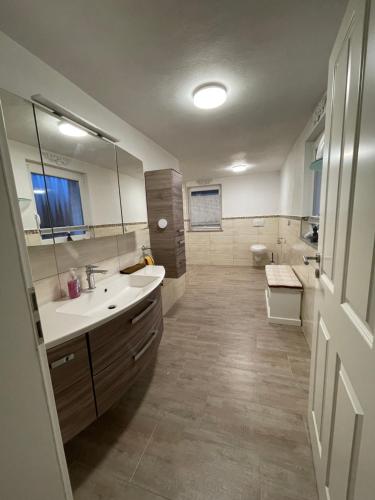 a large bathroom with a sink and a toilet at Ferienwohnung Anna in Hoppstädten-Weiersbach