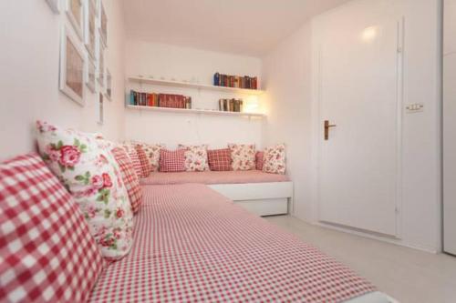 a living room with a red and white checkered couch at Vintage Apartment Rovinj Old Town in Rovinj