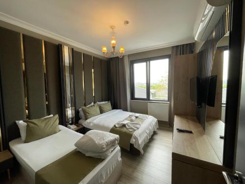 Postel nebo postele na pokoji v ubytování New Taksim Hotel